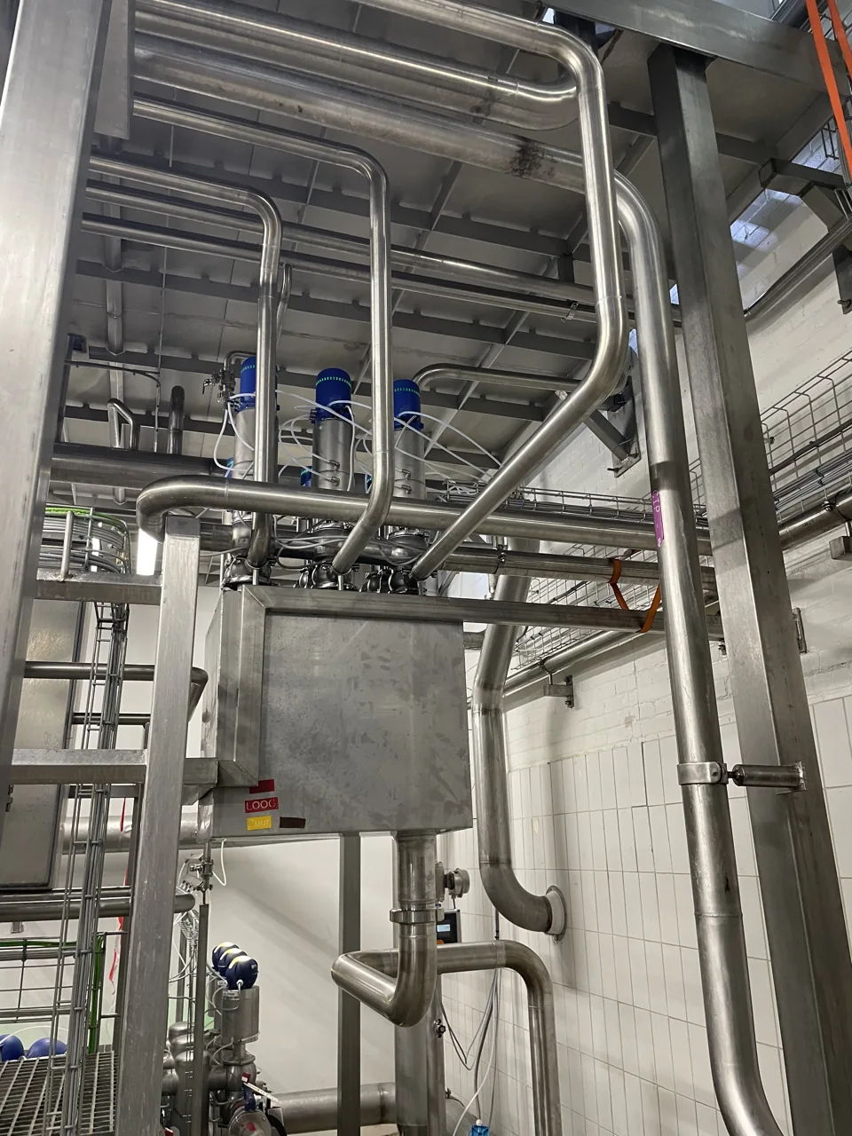Hygi&euml;nisch RVS-leidingwerk met aangedreven afsluiters in een productiehal